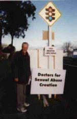 Protester with sign: Doctors for Sexual Abuse Creation